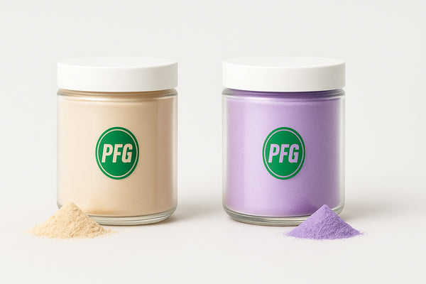 Two clear jars with white lids, each filled with a single shimmering pearlescent powder—one champagne and one lavender. Both jars feature the PFG logo and are displayed with small piles of matching powders on a light grey background.
