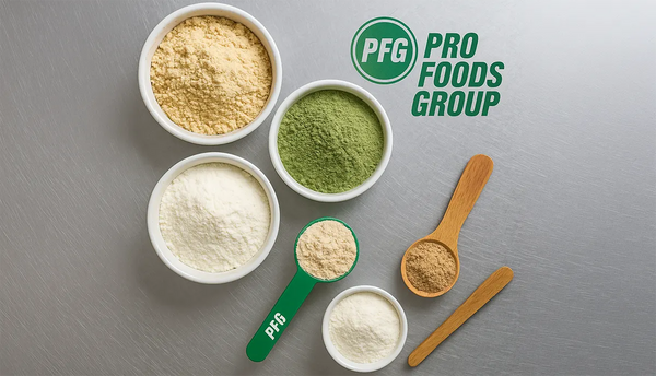 Overhead view of powders in bowls with branded Pro Foods Group measuring scoop and wooden utensils, showcasing nutritional powders, superfood blends, instant drink mixes, and specialty baking flours.