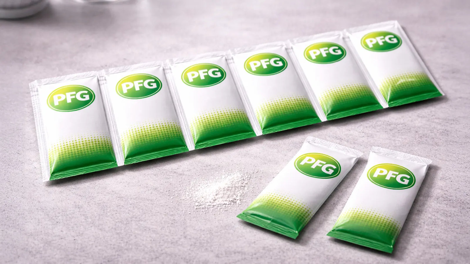 Connected strip of Pro Foods Group single-use packets arranged on a clean surface with two separated units and a small amount of powder, highlighting perforated tear-off design and flexible portioning